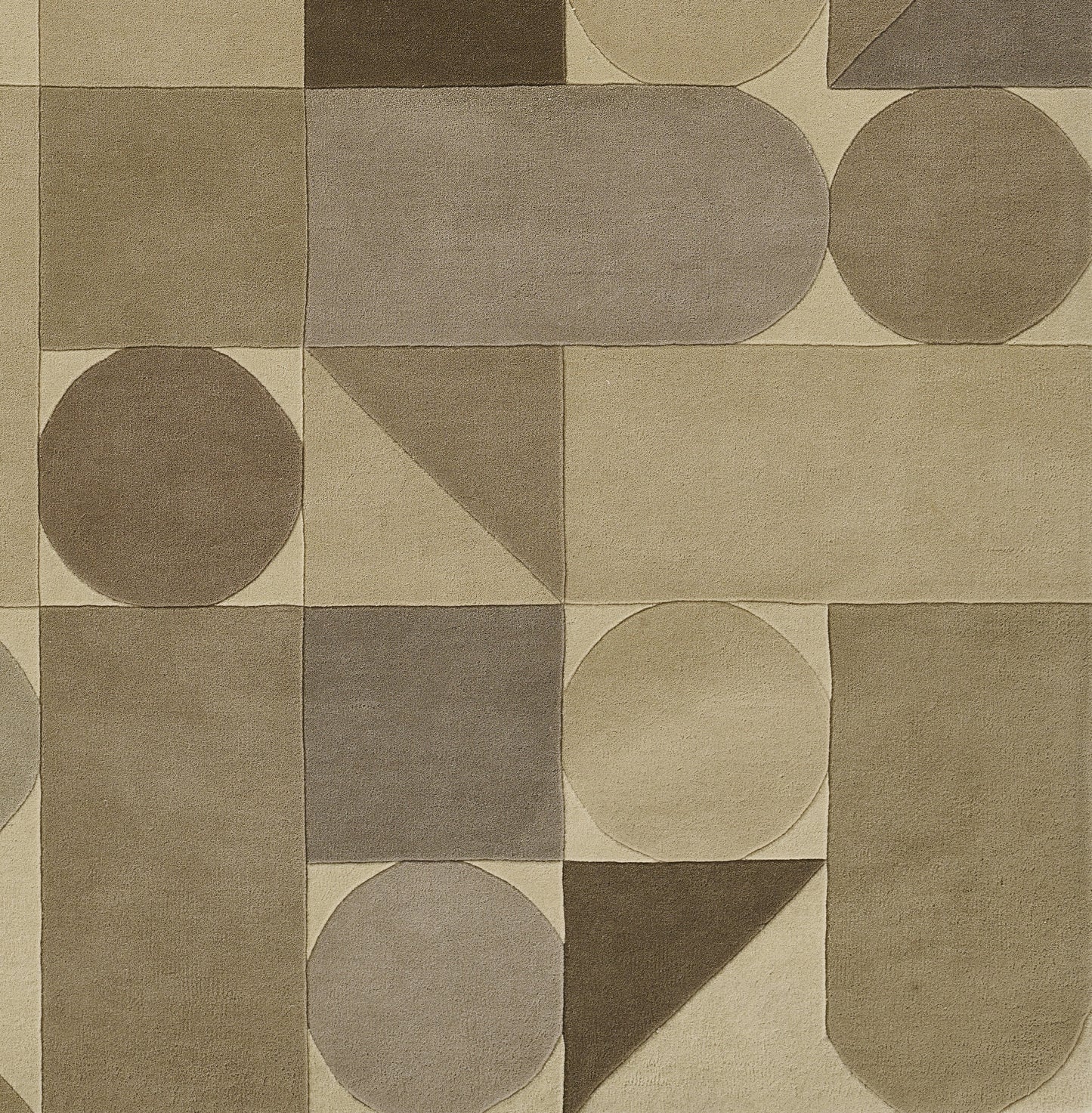 Neutral geometric area rug in beige, taupe and brown with circles, semicircles, triangles and rounded shapes.