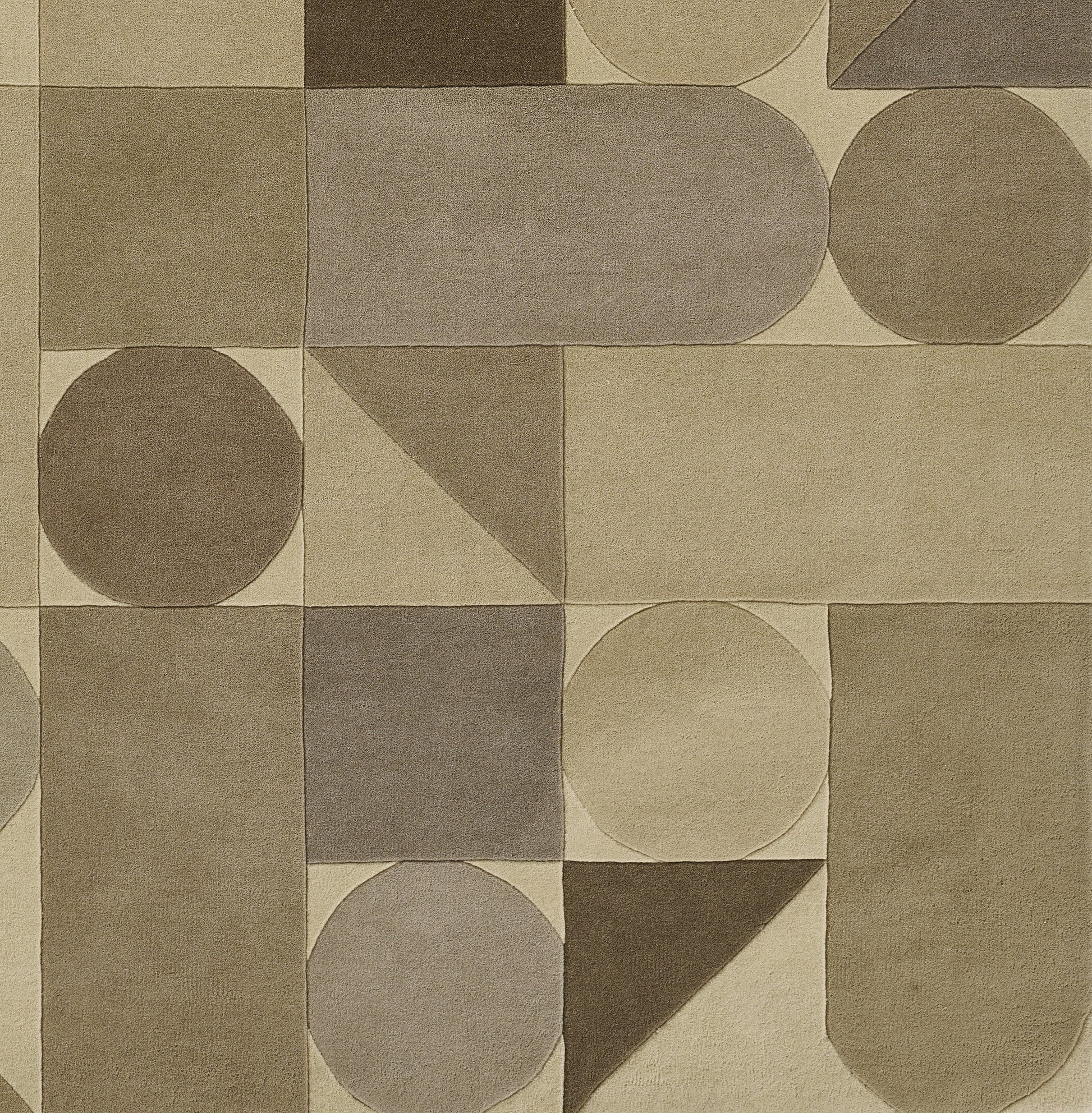 Earth-toned geometric rug with circles, semicircles, triangles and rounded squares in beige, taupe and brown.