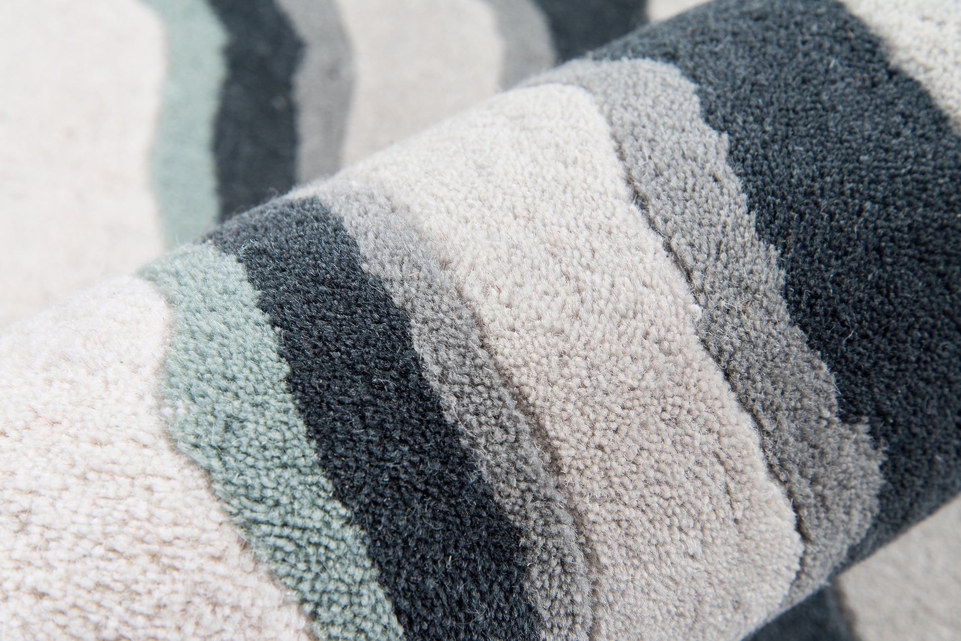 Soft boucle rug (4' x 6') with cream, gray, teal & navy stripes; close-up textured weave.