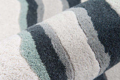 Soft boucle rug (4' x 6') with cream, gray, teal & navy stripes; close-up textured weave.