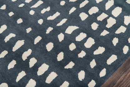 Navy blue runner rug with irregular ivory spots in a modern abstract pattern; edge visible on wood floor.