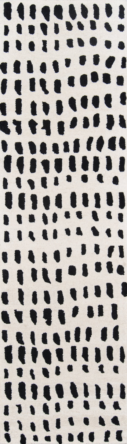 Ivory rug runner with irregular black brushstroke dashes in a vertical, dotted abstract print; suitable for hallway or decor.