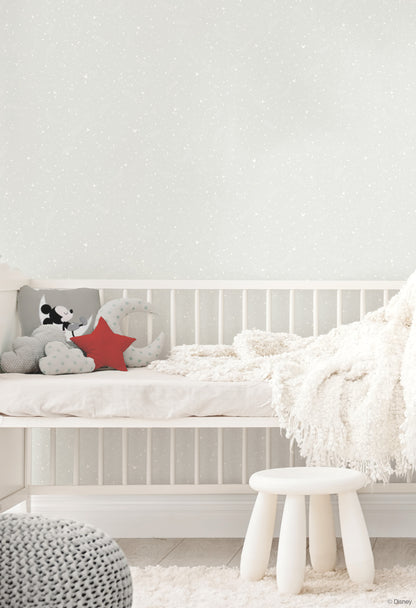 Grey wallpaper in a nursery featuring a Mickey Mouse star pattern on the wall.