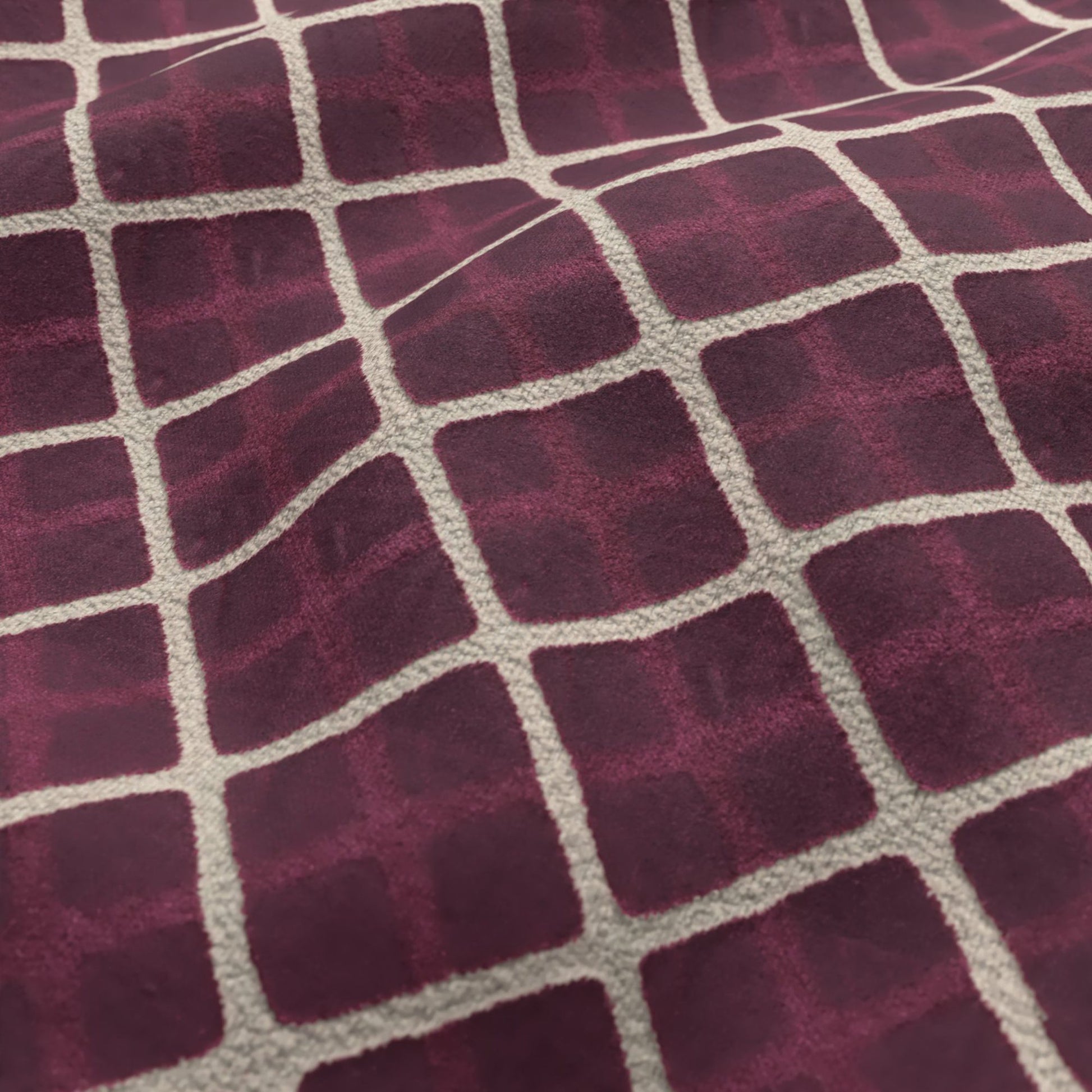 Raspberry and cream velvet fabric with a diamond grid pattern; plush texture.
