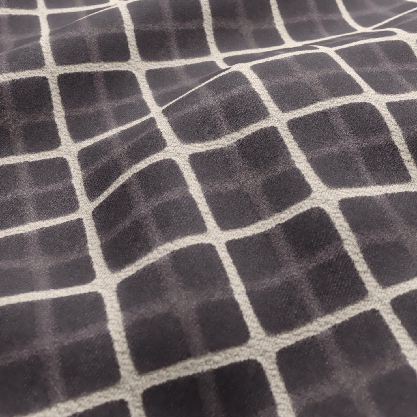 Charcoal velvet fabric with a cream geometric diamond pattern.