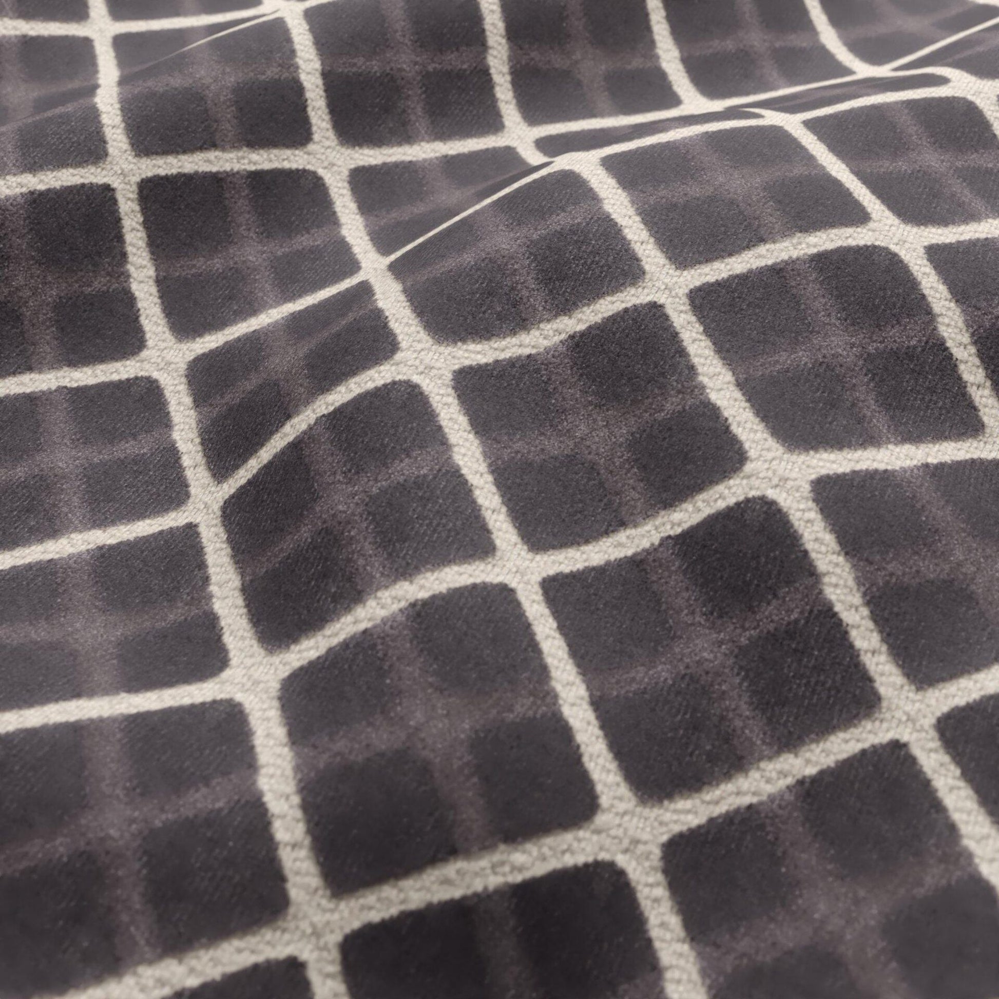 Charcoal velvet fabric with a cream geometric diamond pattern.