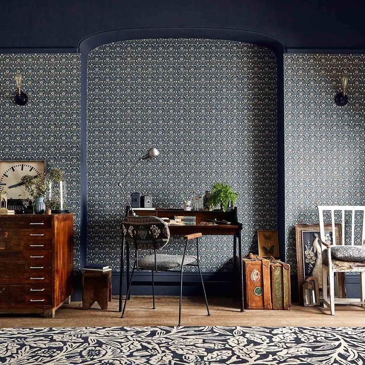 Morris & Co. Morris Bellflowers Wallpaper in Indigo/Linen featuring a small-scale interlocking floral pattern inspired by a bestselling William Morris carpet design. This Arts & Crafts designer wallpaper is ideal for all four walls in living rooms, bedrooms, dining rooms, hallways, English cottage homes, traditional, vintage, and heritage-inspired interiors.