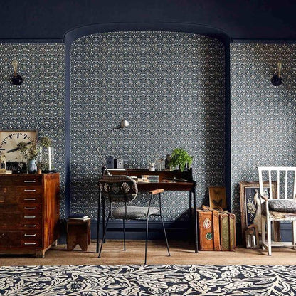 Morris & Co. Morris Bellflowers Wallpaper in Indigo/Linen featuring a small-scale interlocking floral pattern inspired by a bestselling William Morris carpet design. This Arts & Crafts designer wallpaper is ideal for all four walls in living rooms, bedrooms, dining rooms, hallways, English cottage homes, traditional, vintage, and heritage-inspired interiors.