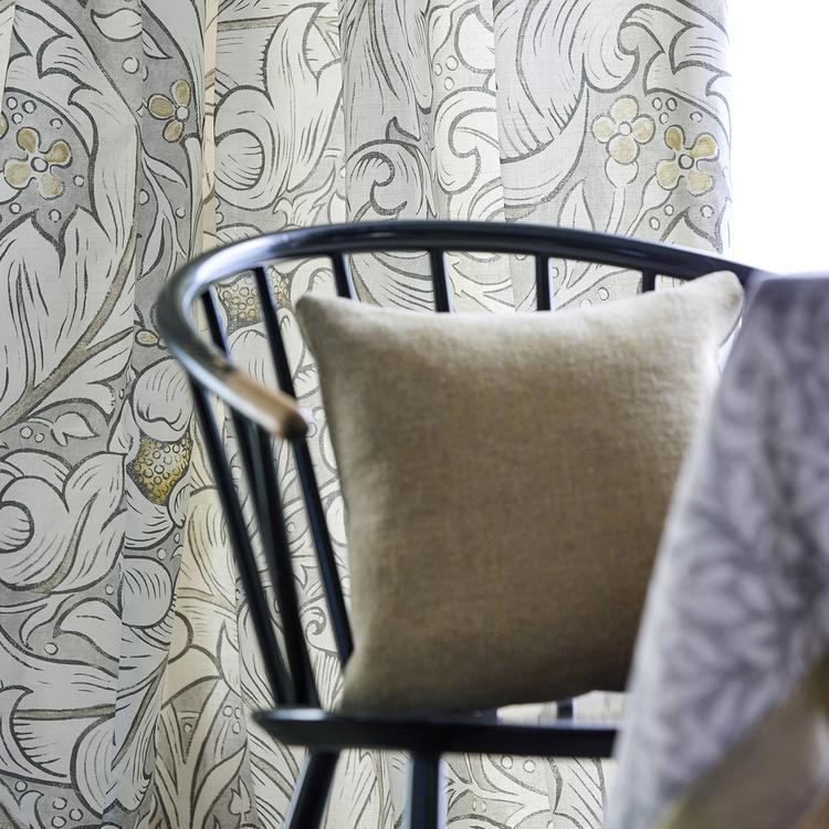 William Morris Pure Bachelors Button Print Fabric in Horned Poppy Grey featuring bold swirling floral leaf patterns in a monochrome Arts & Crafts design. This Morris & Co fabric shows dramatic medieval-inspired botanical artwork on a linen blend base, ideal for drapery panels, roman shades, upholstery, headboards, pillows, and luxury interior design projects.