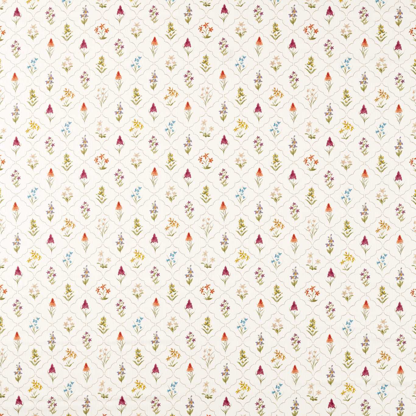 Beige fabric with a repeating diamond lattice of small multicolor floral motifs in pink, blue, orange and green.