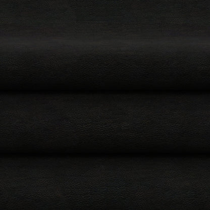 Black solid fabric in flat lay with horizontal folds and subtle grain.