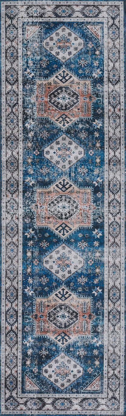 Narrow blue rug with repeating white and peach diamond medallions on a deep blue field and a light ornate border.