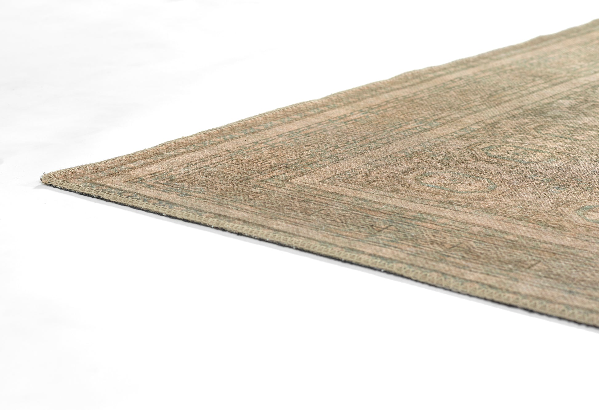 Beige-green rectangular rug with subtle geometric motif and low-pile weave, oriental-inspired style.