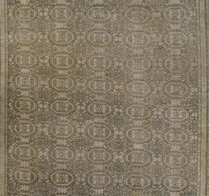 Muted green-beige geometric area rug with repeating octagonal medallions and ornate border.