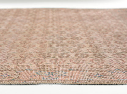 Pink-taupe flatweave rug with subtle geometric motifs, low pile, woven texture for living spaces.