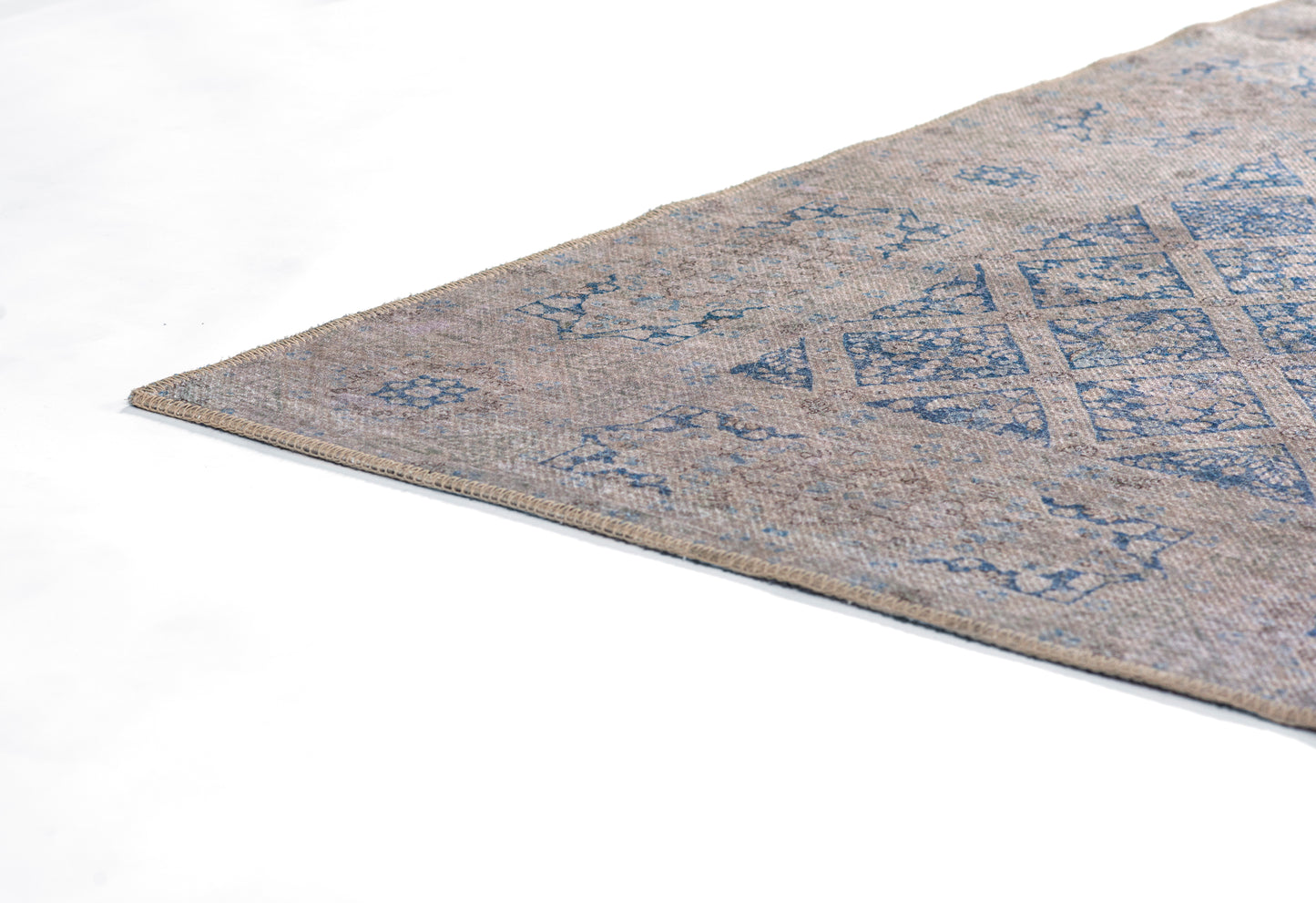 Beige and blue geometric flat-weave rug with diamond motifs; rectangular kilim-style floor rug, wool-like material.