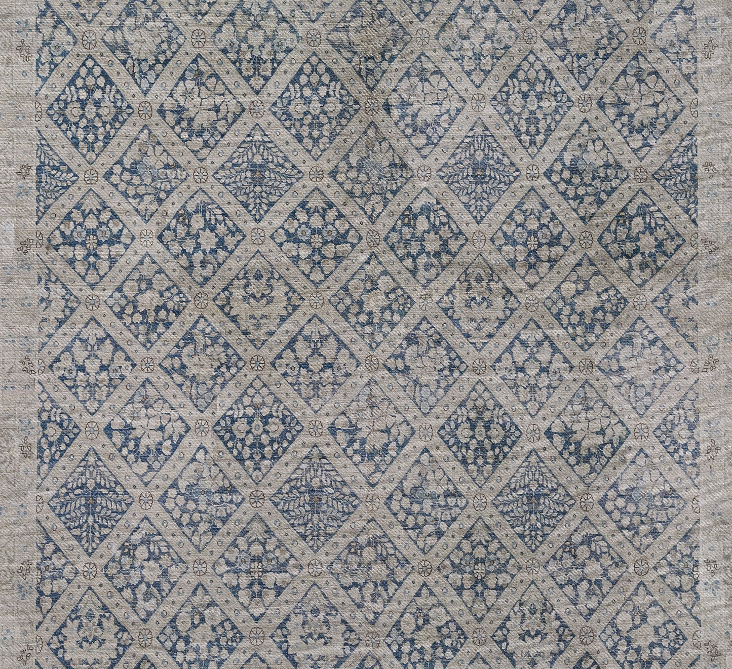Blue-beige diamond lattice rug with floral medallion clusters; woven textile for boho or traditional home decor.