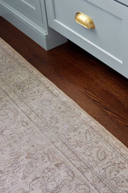 Light gray rug with a beige pattern on a dark wood floor (2' x 3').