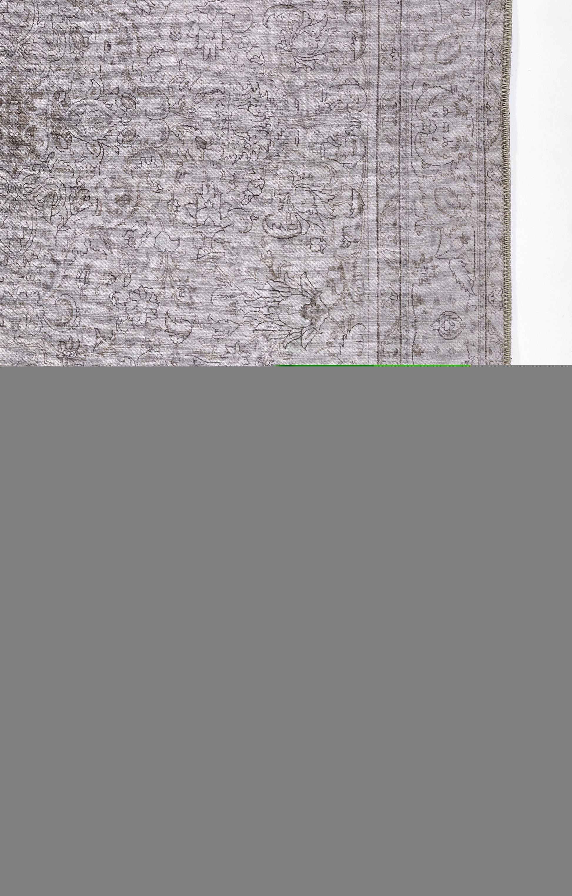 Gray oriental-style rug with an ornate floral pattern and double bordered edges.