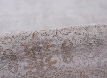 Taupe-gray damask patterned rug with a soft velvety texture and floral scroll design, 2' x 3'.