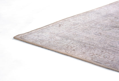 Gray-beige oriental rug with subtle floral motif, low-pile weave, bound edges, rectangular floor decor
