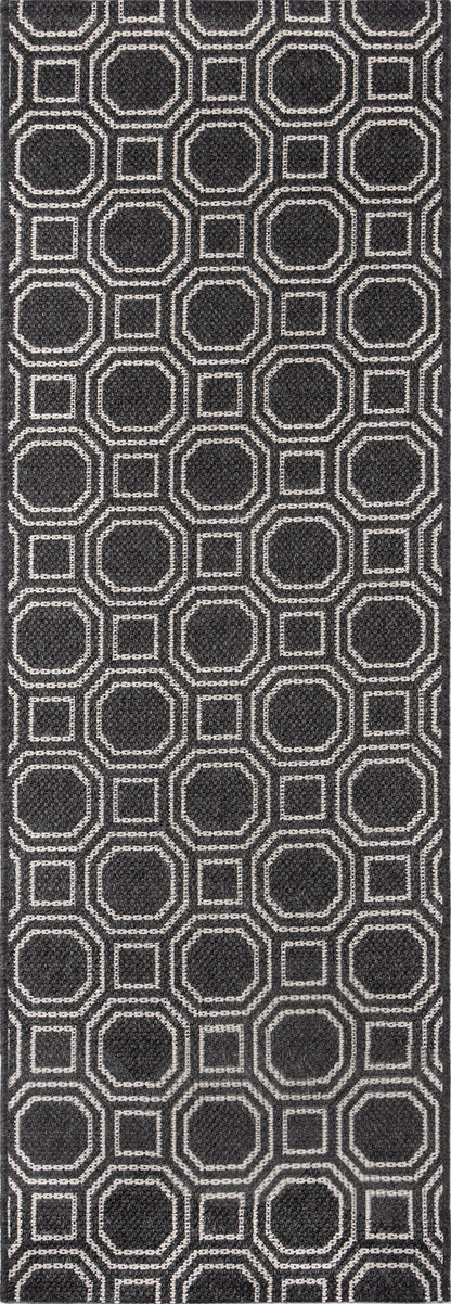 Dark charcoal rug with a repeating light-gray outlined hexagon pattern; geometric modern design.