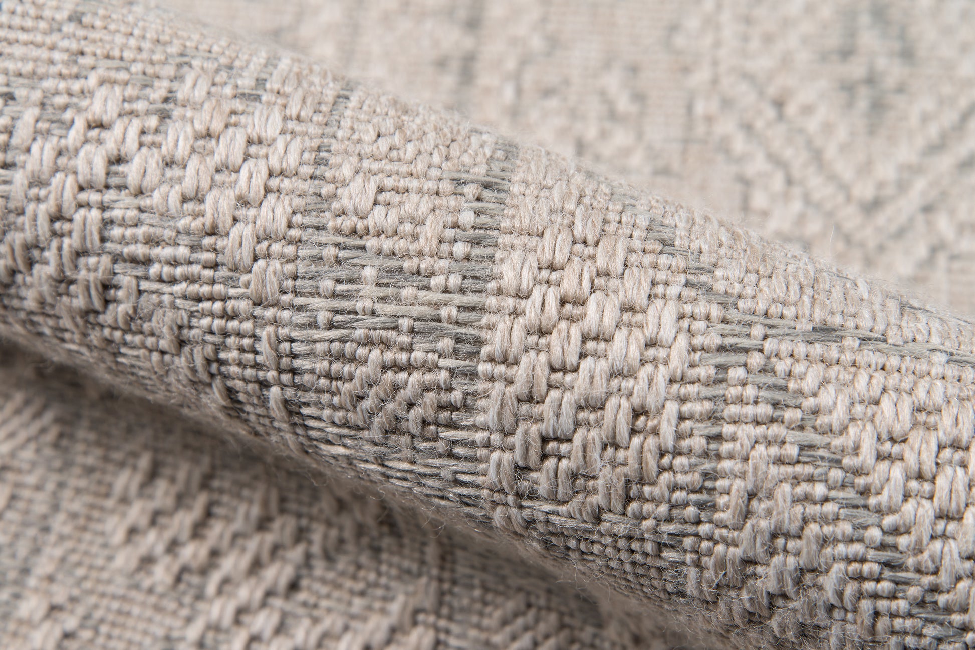 Close-up of gray & beige woven rug fabric with a textured geometric pattern; thick, cozy runner rug.