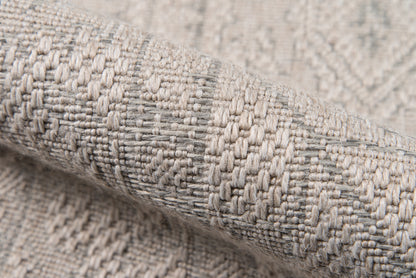 Close-up of gray & beige woven rug fabric with a textured geometric pattern; thick, cozy runner rug.