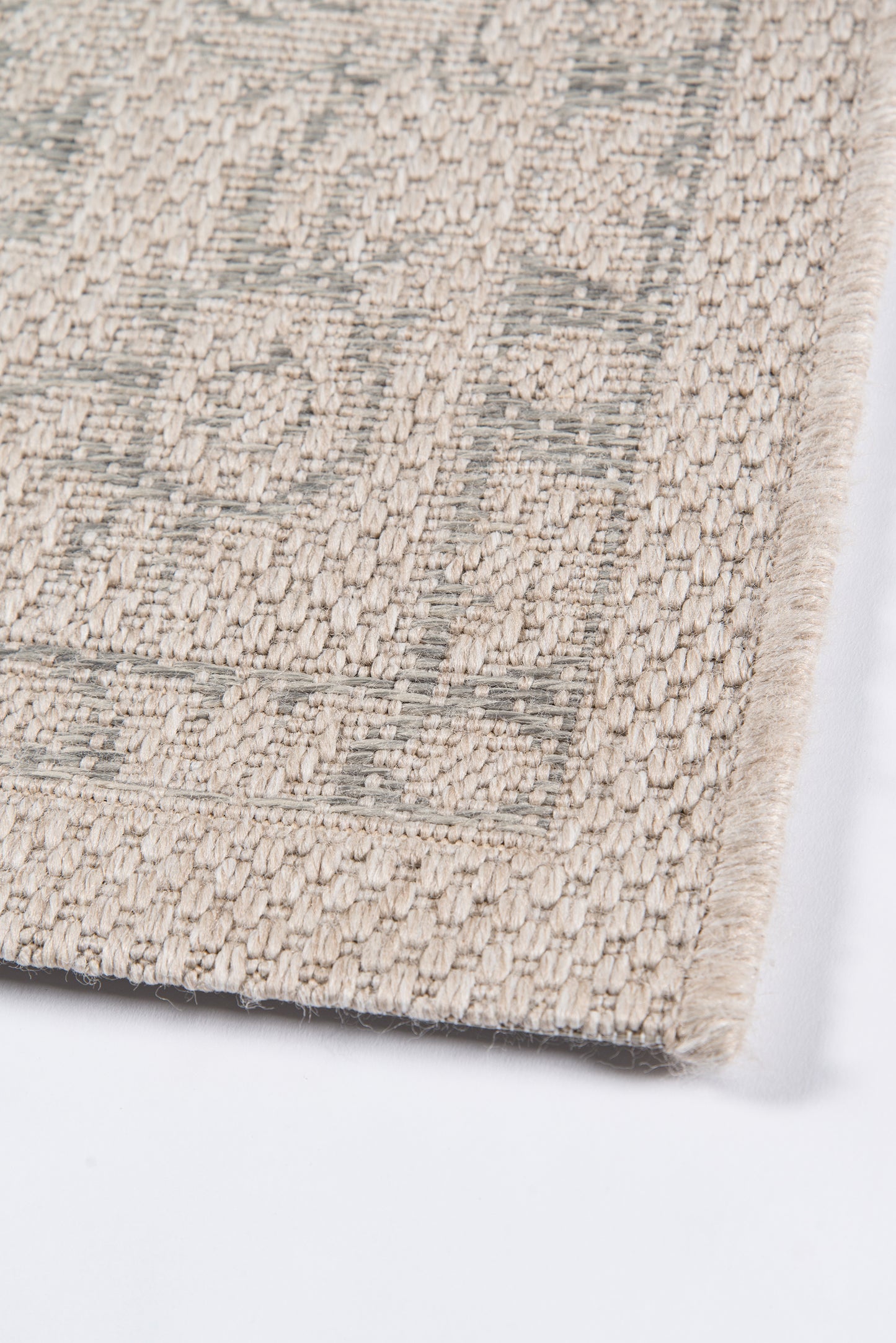 Beige and gray woven runner rug with a geometric border and dense looped texture; neutral home decor.
