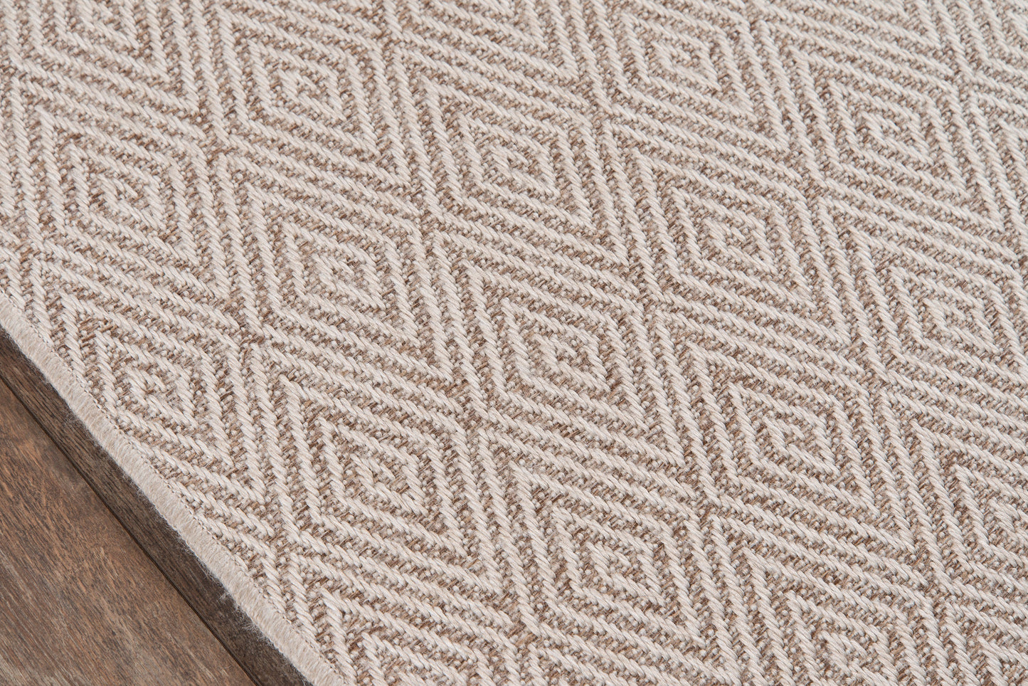 Beige and cream geometric diamond rug with textured weave; rectangular, indoor living room decor.