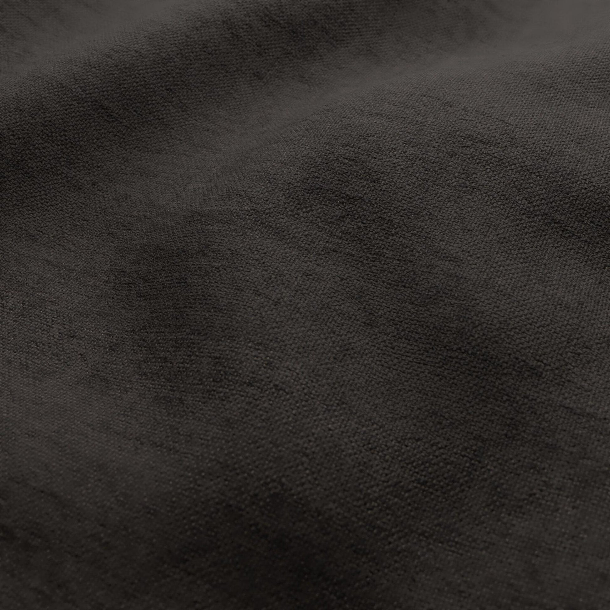 Brown fabric close-up showing a basketweave texture and subtle folds.