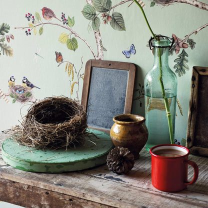 Sanderson Woodland Chorus DWOW215706 wallpaper featuring detailed birds, butterflies, and berries on a sky-blue background; premium designer wallcovering ideal for living rooms, bedrooms, and dining spaces.