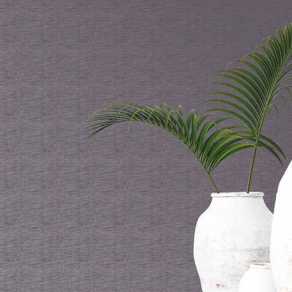 White ceramic vases with green palm leaves against a textured gray wall, modern home decor centerpiece.