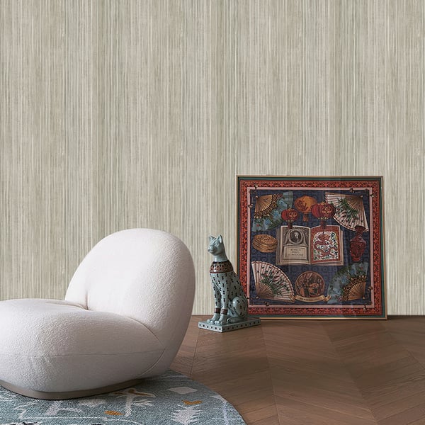 Soft white curved lounge chair in plush fabric, turquoise ceramic cat statue, and a vibrant framed artwork on a wooden floor.