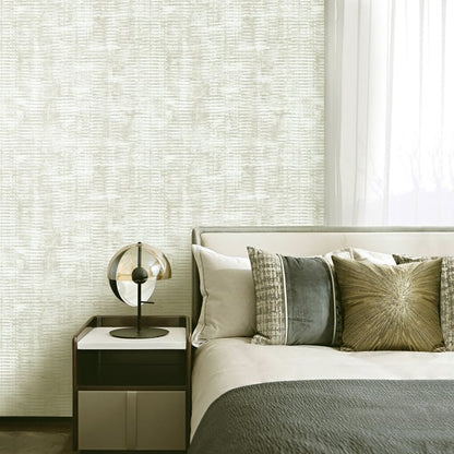 Neutral-toned bedroom with textured wallpaper, upholstered bed, gray beige cushions, and round glass globe lamp on a dark wood nightstand.