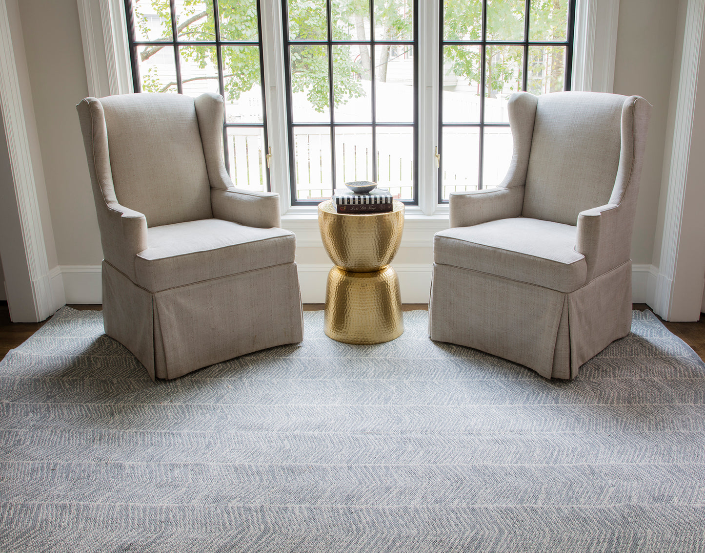 Light gray rug laid on the floor in a sunlit room.