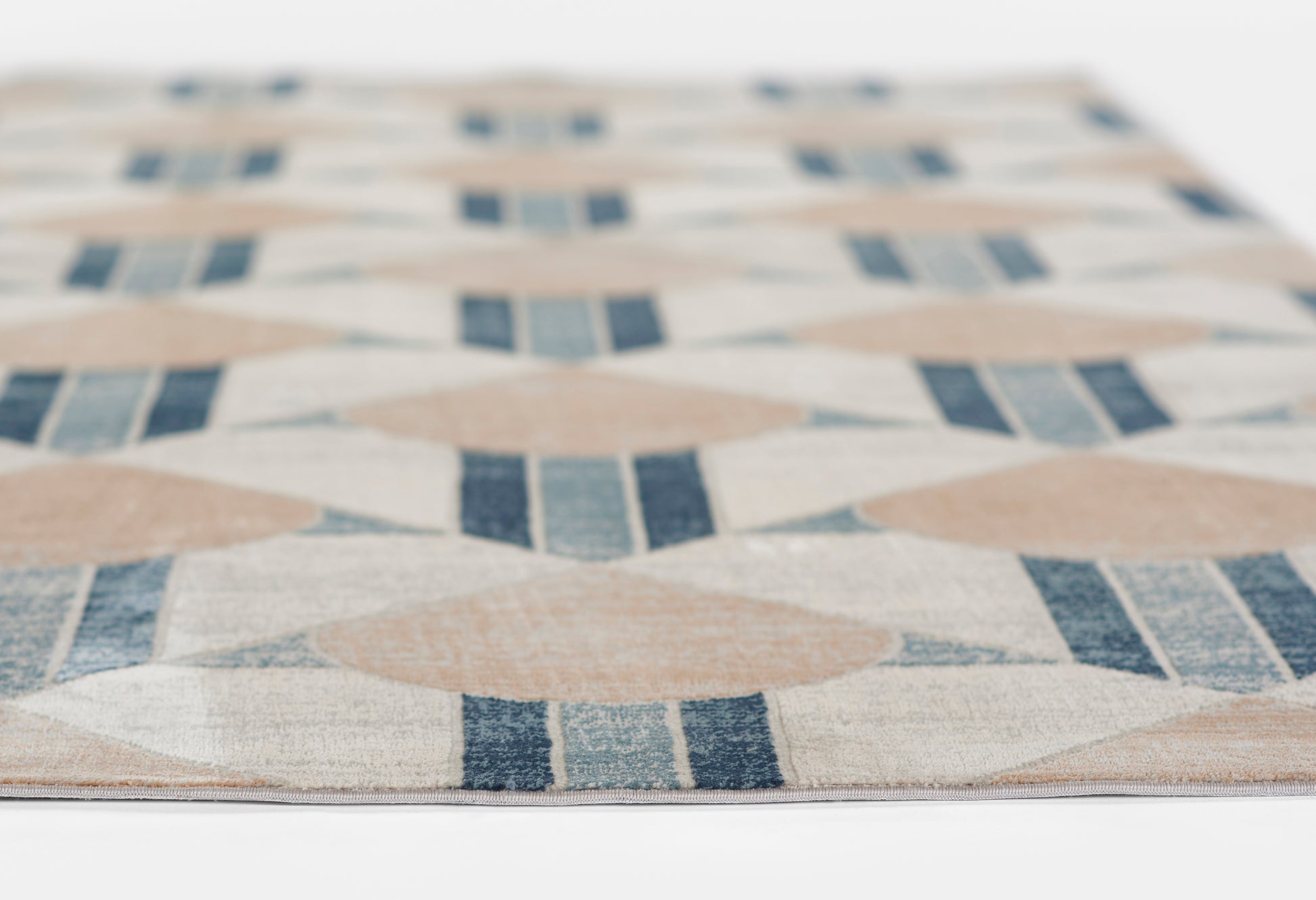Beige geometric rug with navy blue diamond and stripe motif for modern decor
