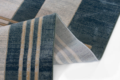 Navy blue striped woven rug with beige stripes; folded edge reveals lighter backing for modern coastal floor decor.