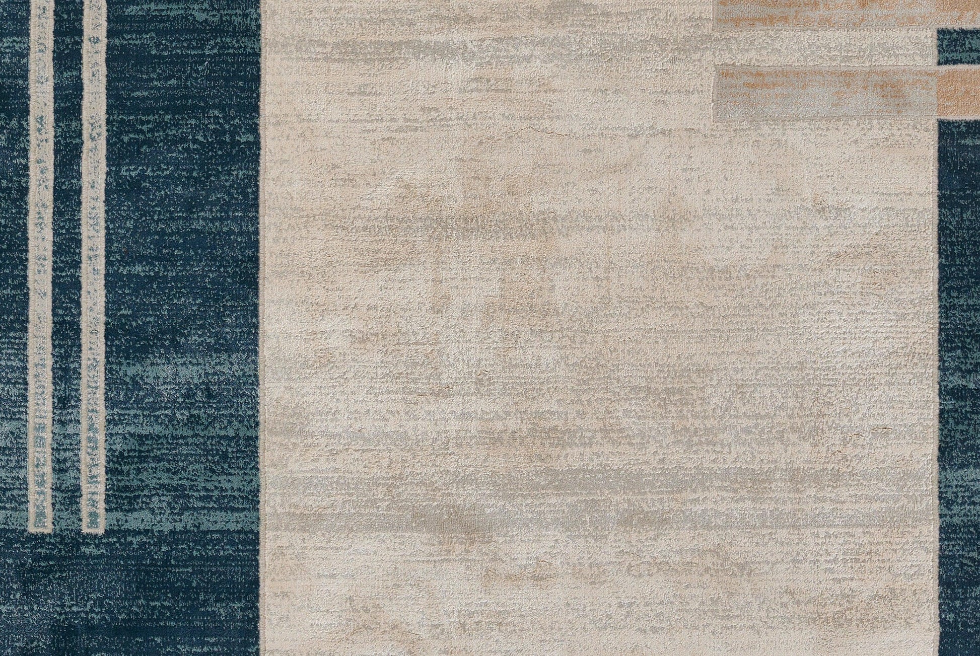 Modern abstract rug with navy blue borders, cream central field, and beige geometric accents; woven texture.