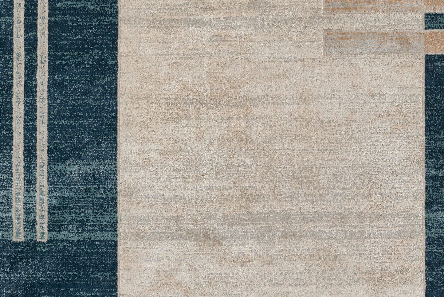Abstract blue and beige area rug with dark blue left panel, beige central field, tan accents, modern geometric pattern.