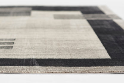 Modern geometric area rug in beige with charcoal border and block accents; low-pile.