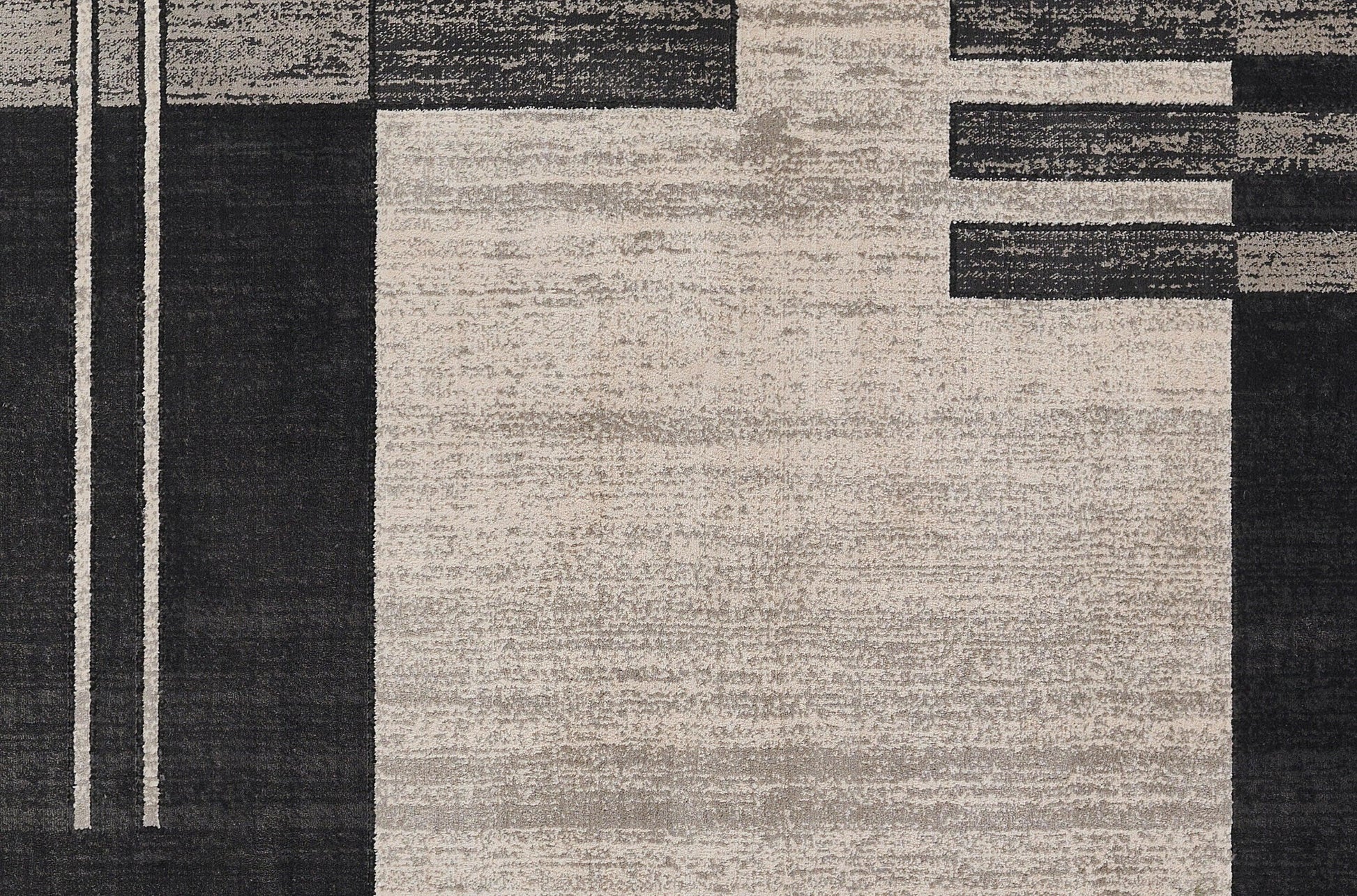 Geometric abstract rug in black, dark gray and beige with vertical stripes and rectangular blocks; modern style.