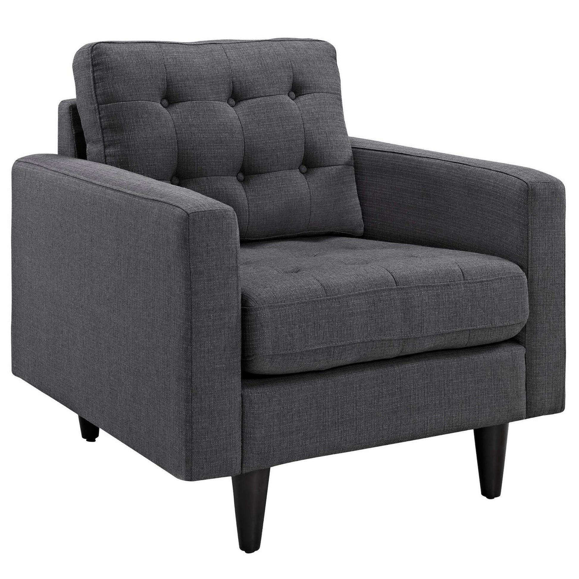 Dark gray tufted fabric accent chair with buttoned back, wide arms, cushioned seat, and tapered black legs.