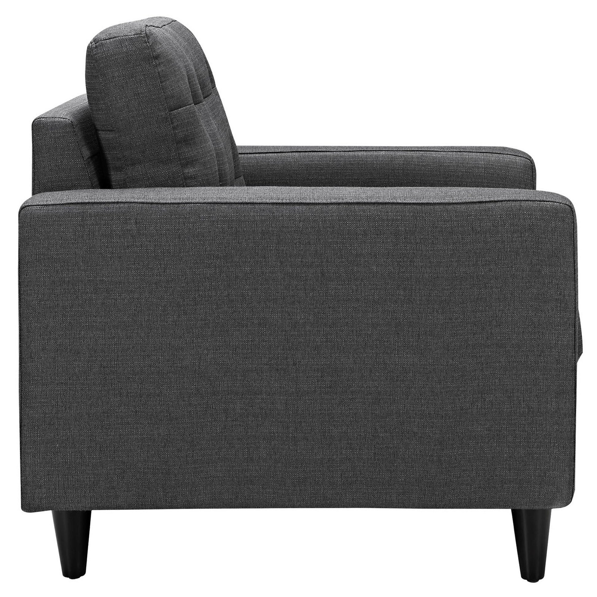 Dark gray fabric upholstered modern armchair with square arms, tall back cushion and black tapered legs.