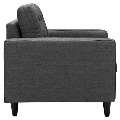 Dark gray fabric upholstered modern armchair with square arms, tall back cushion and black tapered legs.