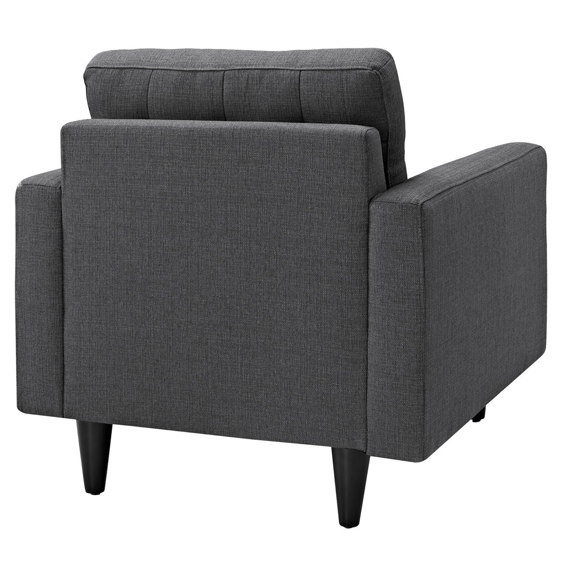 Dark gray fabric armchair with square arms, cushioned back, and black tapered legs; modern mid-century style.