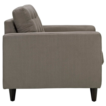 Taupe fabric upholstered modern armchair with boxed back cushions and tapered dark legs.