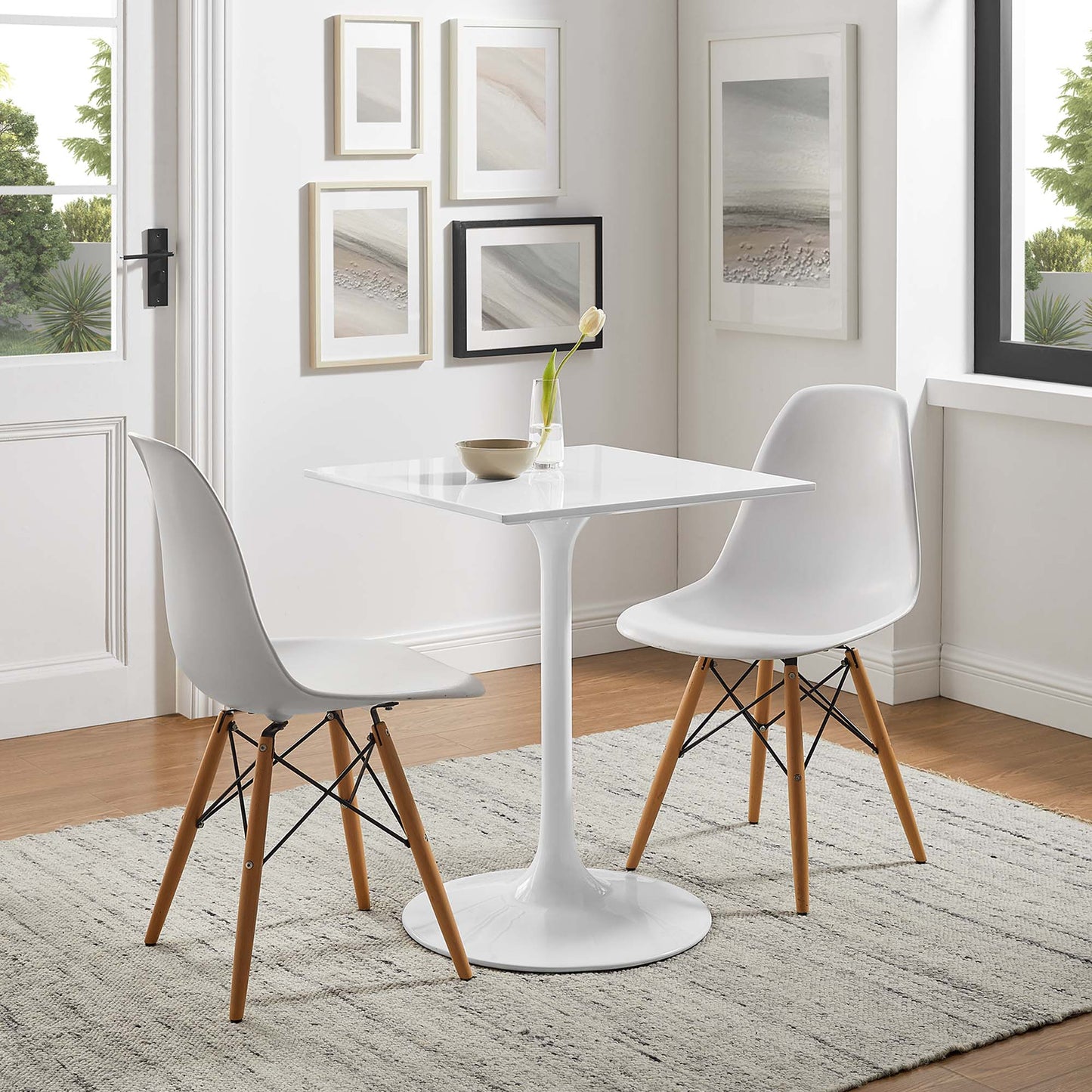 White tulip pedestal dining table with square top, flanked by white mid-century molded-shell chairs with wooden legs.