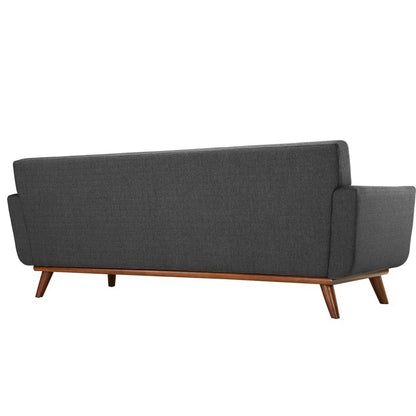 Charcoal gray fabric sofa in mid-century style with tapered wood legs and exposed frame.