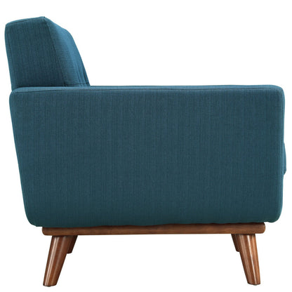 Teal fabric mid-century armchair with tapered wooden legs; side view shows cushioned back and boxy, compact shape.